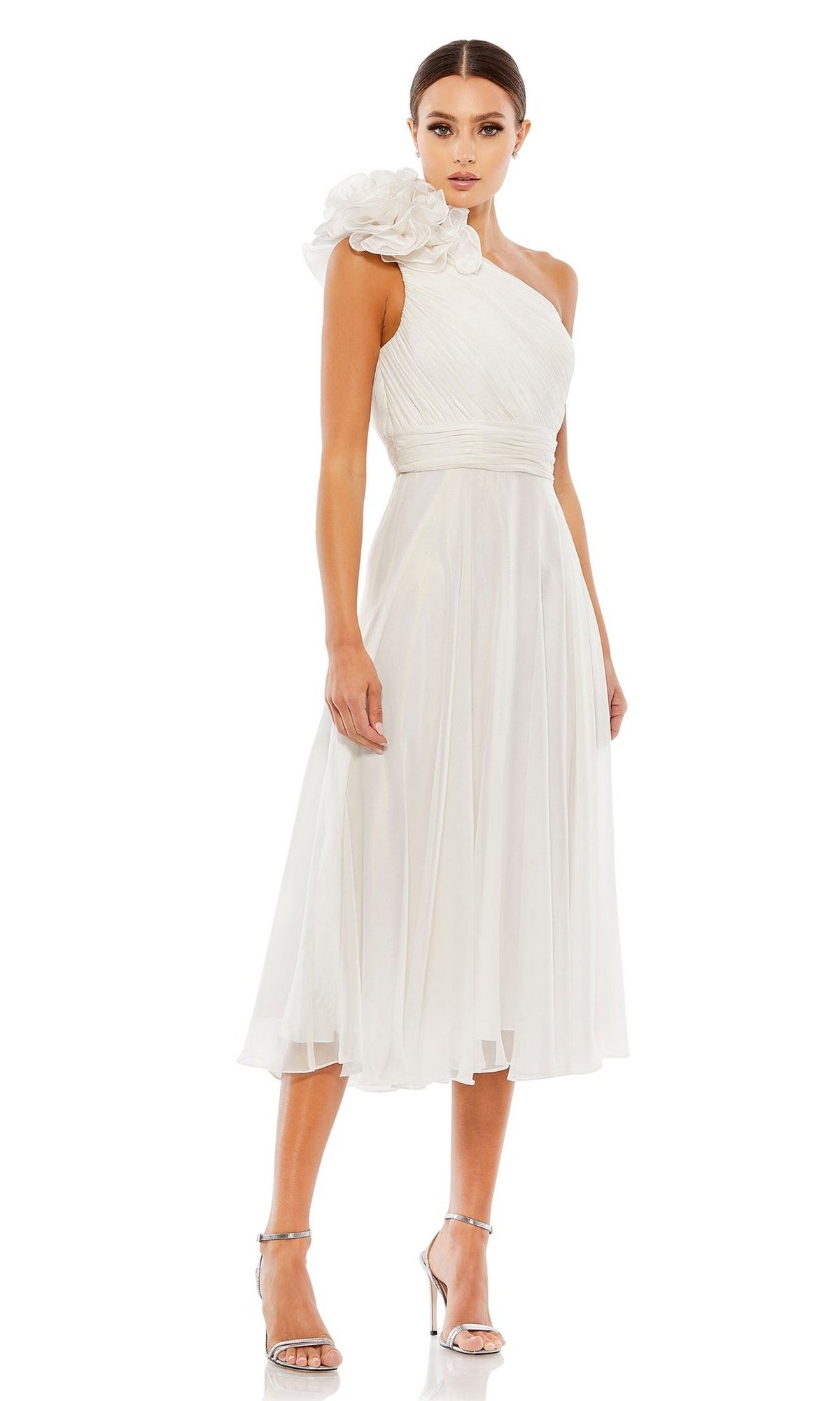 Woman wearing the Knee-Length White Party Dress: Mac Duggal 49491, a one-shoulder style with bold floral detail and silver heels—perfect for any special occasion.